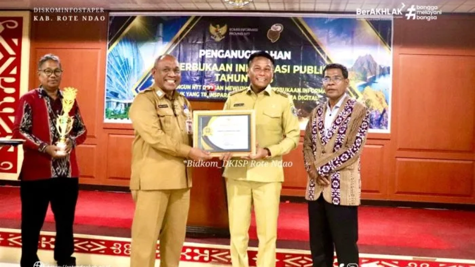 Asisten Administrasi Umum Setda Provinsi NTT Semuel Halundaka, S.IP,M.Si menyerahkan Penghargaan Keterbukaan Informasi Publik kepada Bupati Rote Ndao Paulus Henuk, SH.